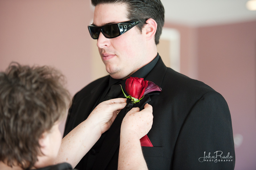 Bridegroom pictured getting boutonniere pinned  