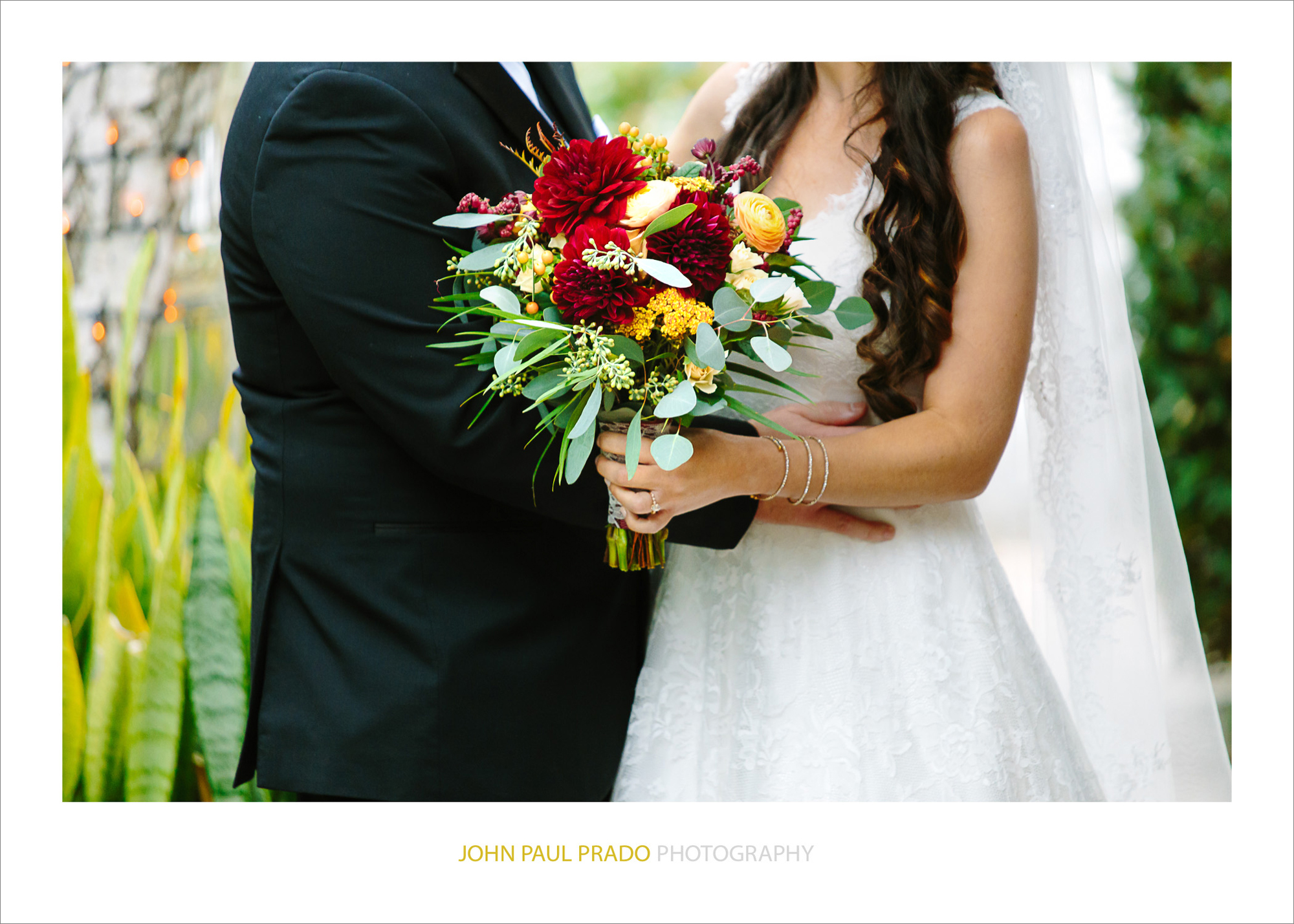 Husband & wife holding flower bouquet