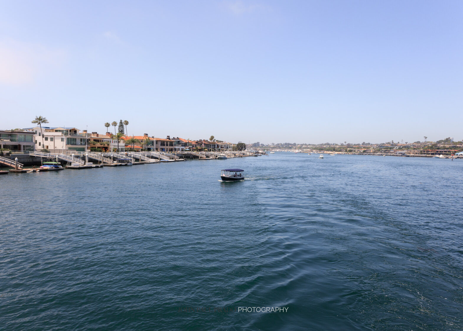 A boat cruising the Newport harbor in Newport Beach California