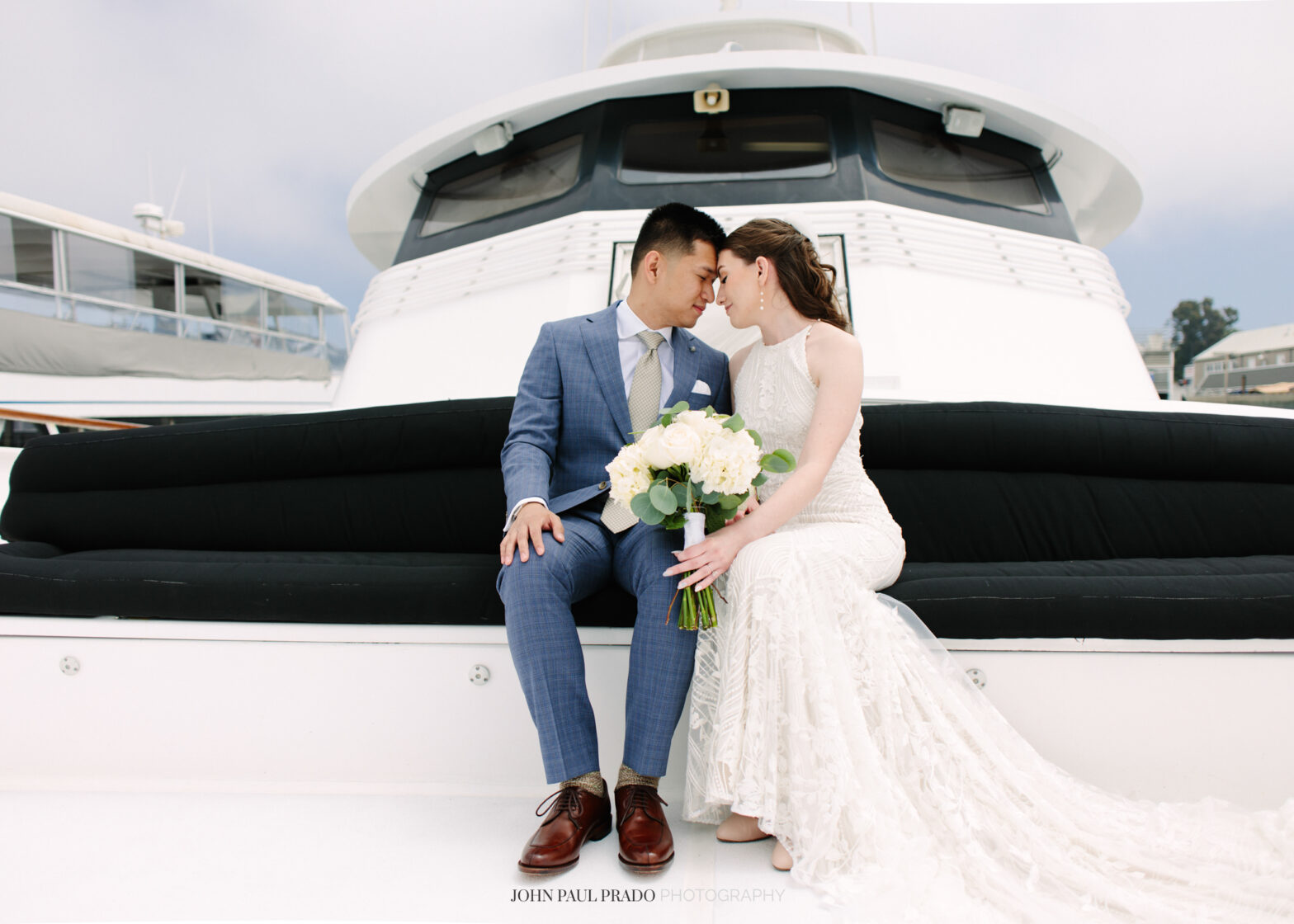 Newlywed portraits on a Newport Beach city cruise