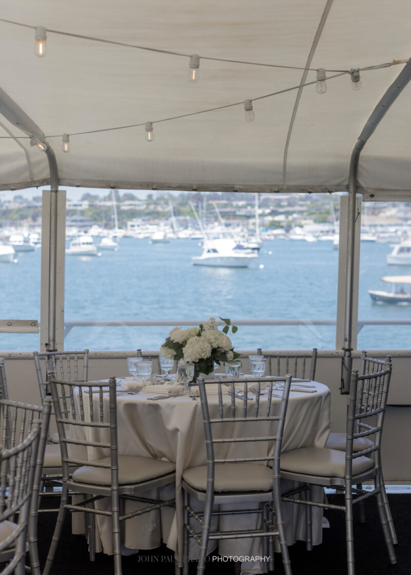 Wedding reception table, white linen, white flowers, ocean view