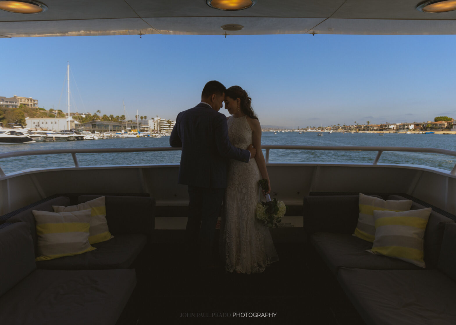 Wedding couple cruising Newport harbor poses for a photo